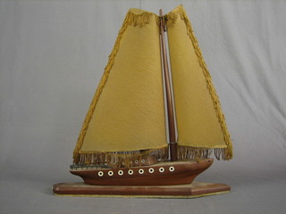 An Art Deco wooden table lamp in the form of a yacht