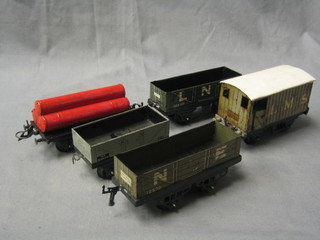 A Hornby LNS break van, a North Eastern Railways drop sided truck, do. LNE, 1 other and 3 red painted tubes raised on a flatbed truck