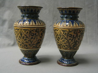 A pair of Doulton Lambeth salt glazed vases, raised on circular spreading feet, the base marked Doulton Lambeth and impressed 1883 h, 9"