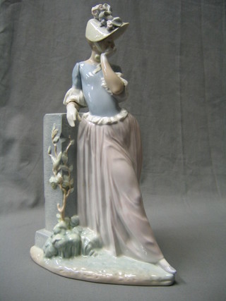 A Lladro figure of a standing bonnetted lady by a pillar, the base incised L2JU, 40" (finger chipped)