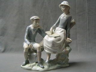 A Lladro figure group of a seated boy and girl on a tree stump, the base incised 12, 12"