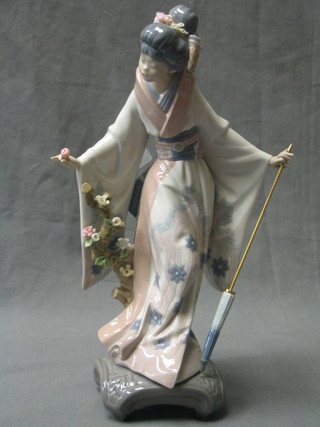 A Lladro figure of a standing Geisha girl with parasol, the base marked F5M, 11" (parasol possible broken?)