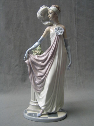 A Lladro figure of a standing flapper girl with ostrich feather, the base marked 5283 A11M, 13"