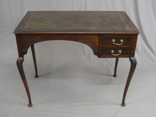 An Edwardian mahogany writing table with inset tooled leather writing surface fitted 2 drawers, raised on cabriole supports 36"