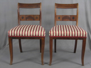 A set of 6 Georgian inlaid mahogany bar back dining chairs with plain carved mid-rails and upholstered seats, raised on sabre supports 