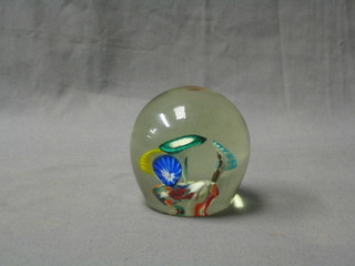 A glass paperweight with stylised floral decoration 3"