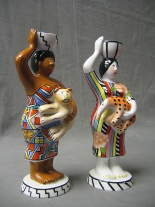 A pair of 20th Century Villeroy & Bosch candle sticks in the form of standing natives 10"