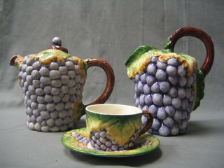A 20th Century 3 piece Portuguese tea set with teapot cup, saucer and large cream jug all with vinery decoration
