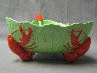 A Carltonware salad bowl in the form of lettuce leaves supported by 3 lobsters together with a pair of matching salad servers (1 f)