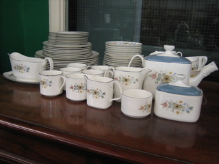 A 65 piece Royal Doulton Pastorale pattern tea/dinner service comprising 9 dinner plates 10", 9 side plates 8", 9 tea plates 7 1/2", 2 twin handled bread plates 9 1/2", 10 saucers 6", 8 cups, 6 coffee cups and 6 saucers, sauce boat and stand, teapot, cream jug, milk jug, open sugar bowl, lidded sucrier (some light contact marks and some rubbing to the silver banding)