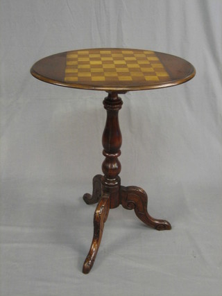 A Victorian oval inlaid mahogany games table, the top inlaid a chessboard and raised on a pillar and carved tripod base 22"