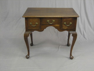 An 18th/19th Century oak low boy, fitted 1 long drawer flanked by 2 short drawers, raised on cabriole supports 30"