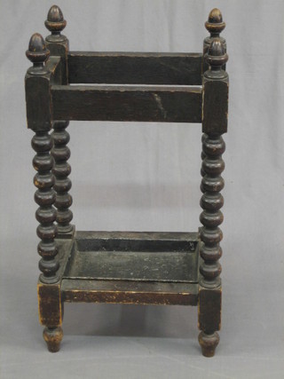 A Victorian carved oak umbrella stand, raised on bobbin turned supports complete with drip tray 14 1/2"