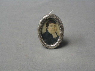 A 19th Century portrait miniature on ivory of a parson, contained in an Edwardian oval embossed silver easel photograph frame, Birmingham 1900, 3"