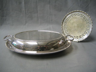An oval silver plated entree dish and cover together with a circular pierced silver plated salver