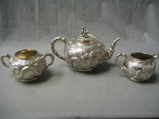 A handsome 19th Century Oriental embossed cast silver 3 piece tea service comprising teapot, twin handled sugar bowl and cream jug 42 ozs