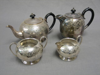 A 4 piece circular engraved silver plated tea service comprising teapot, hotwater jug, twin handled sugar bowl and cream jug