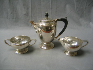 A silver plated 3 piece tea service comprising teapot, twin handled sugar bowl and cream jug by Mappin & Webb,
