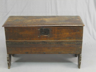 A 17th/18th Century oak coffer of panel construction with hinged lid, fitted a candle box 34"