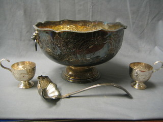 A 20th Century Georgian style embossed silver plated punch set comprising circular punch bowl, raised on a circular spreading foot, together with 6 punch cups