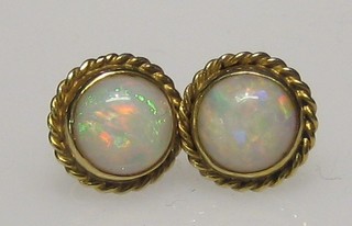 A pair of gold and opal ear studs