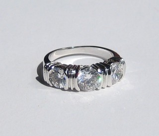 A lady's dress ring set white stones
