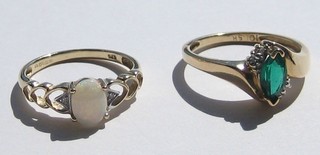 A lady's 9ct gold dress ring set a white stone and a lady's gold coloured dress ring set a green stone