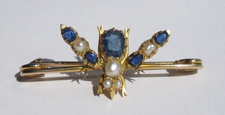 A handsome Edwardian bar brooch in the form of an insect set pearls and blue stones