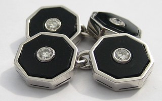 A pair of octagonal white gold and onyx cufflinks set diamonds