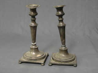 A pair of 1930's Georgian style silver plated candlesticks with bead work borders, raised on square bases with bun feet 12" (f)