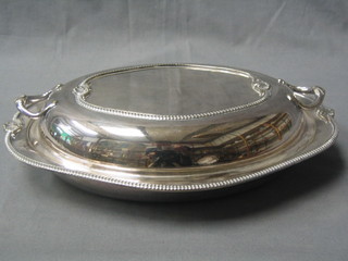 An oval silver plated entree dish and cover