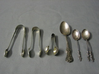 2 pairs of silver sugar tongs, 2 Victorian Scots silver Queens pattern tea spoons, 3 silver apostle spoons and a small silver tea infuser