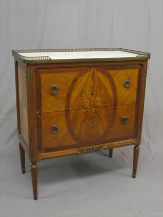 A handsome 19th/20th Century  inlaid French Kingwood commode the top with a pierced brass three-quarter gallery and white veined marble top  above 2 long drawers, inlaid gardening trophies, raised on turned and fluted supports 30"