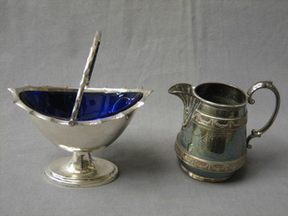 A silver plated boat shaped dish with blue glass liner and swing handle and a Victorian silver plated cream jug