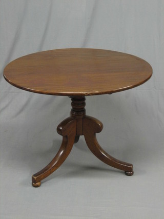A 19th Century circular mahogany snap top tea table, raised on turned pillar and tripod supports 25"