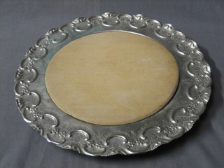 A circular embossed silver plated bread board holder and board