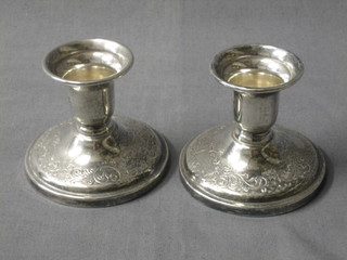 A pair of circular embossed Sterling silver stub candlesticks, the base marked Banks Sterling, 2 1/2"