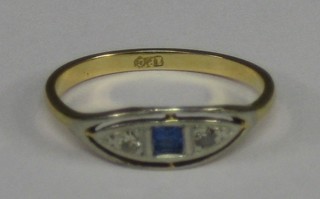 A lady's 9ct gold dress ring set a square cut sapphire and 2 small diamonds