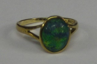 A lady's 9ct gold dress ring set an oval cut opal