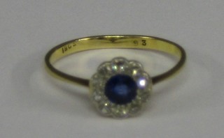 A lady's 18ct gold dress ring set a sapphire surrounded by numerous diamonds