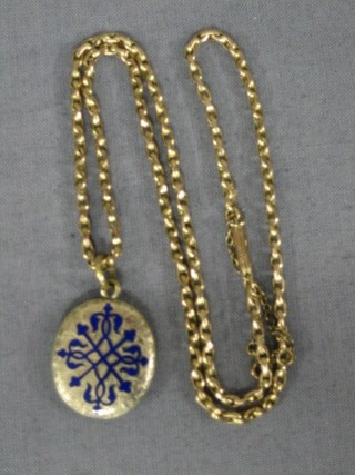 A lady's fine gold chain hung a gold plated and enamelled locket