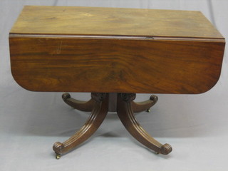 A Georgian mahogany pedestal Pembroke table raised on a turned column with splayed reeded supports 43"