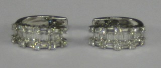 A pair of 18ct white gold earring set baguette cut diamonds and 10 circular cut diamonds (approx 1.28ct)