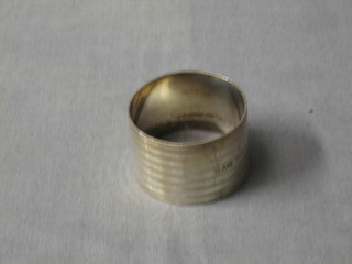 A silver napkin ring with engraved decoration