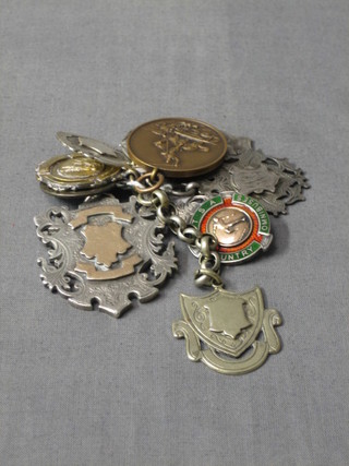 A pierced gilt metal Masonic pendant, 8 silver watch chain medallions and a bronze watch chain medallion