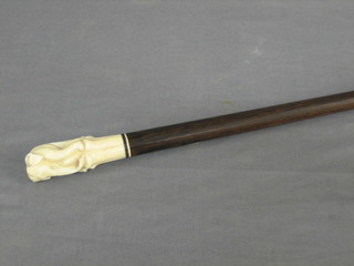 An Eastern turned walking stick with carved ivory handle in the form of a standing elephant