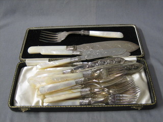A pair of silver plated fish servers with carved mother of pearl handles and a set of 11 silver plated fish knives and forks with carved mother of pearl handles