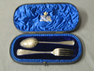 A Victorian silver spoon and fork  christening set with bright cut decoration London 1891, cased