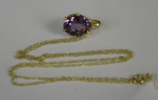 An amethyst pendant contained in a 9ct gold mount hung on a gold chain