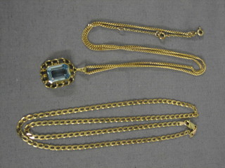 A Continental gold chain and a blue pendant hung on a gold chain